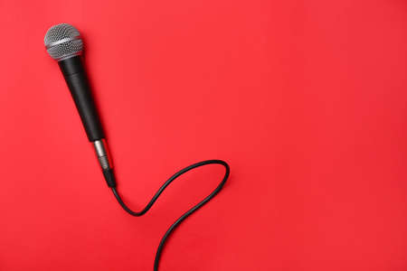 Modern microphone on color backgroundの写真素材