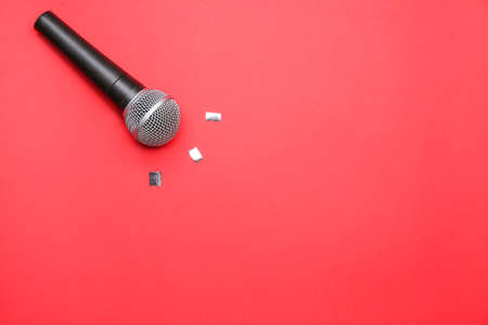 Modern microphone on color background