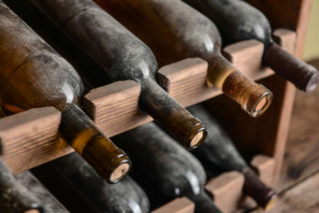 Holder with bottles of wine in cellar, closeupの写真素材