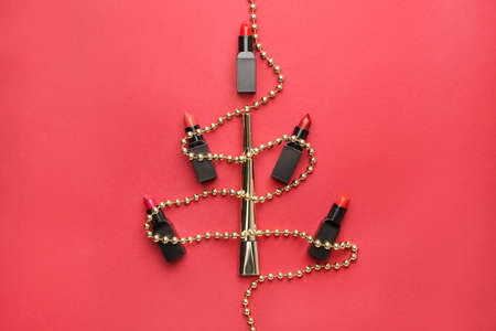 Beautiful Christmas tree made of lipsticks on color backgroundの写真素材