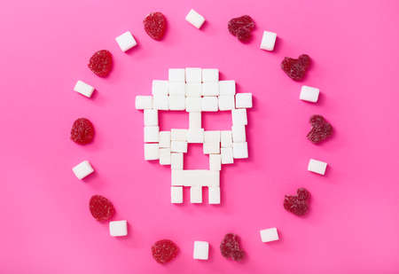 Human skull made of sugar on color backgroundの写真素材