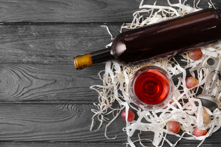 Bottle and glass of tasty wine on wooden tableの写真素材