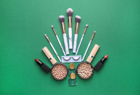 Beautiful Christmas tree made of makeup cosmetics and brushes on color backgroundの写真素材