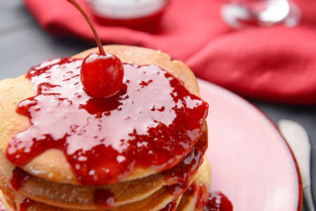 Plate with tasty sweet pancakes on table, closeup