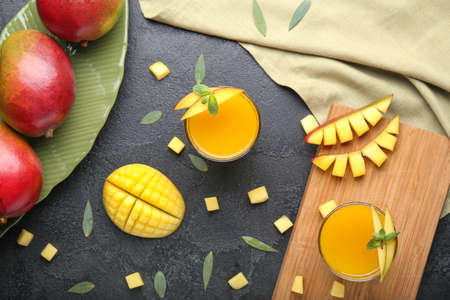 Composition with tasty mango and juice on table