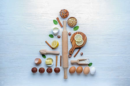 Christmas tree shape made of products and utensils on white backgroundの写真素材