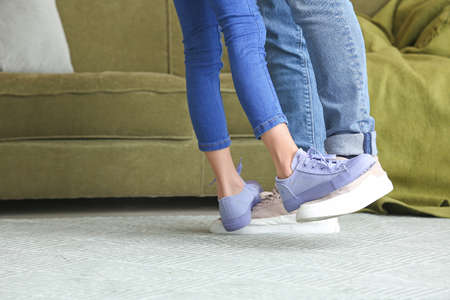 Father with little daughter dancing at home