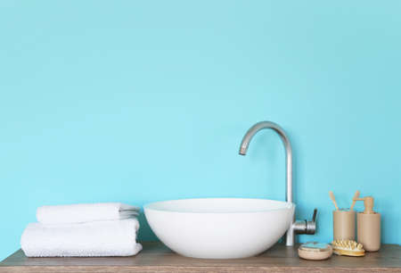 Soft towels and cosmetics near bathroom sinkの写真素材