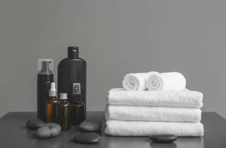 Clean towels and spa supplies on tableの写真素材