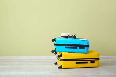 Packed suitcases near color wall. Travel conceptの写真素材