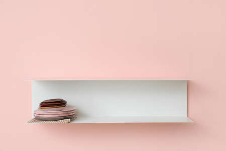 Shelf with clean plates hanging on color wallの写真素材