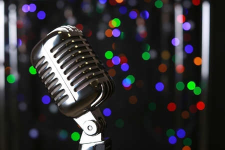 Retro microphone on stage against defocused lightsの写真素材