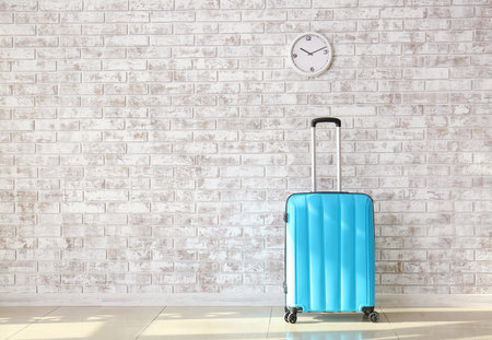 Suitcase near brick wall. Travel conceptの写真素材
