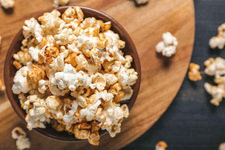 Bowl with tasty popcorn on table, closeupの写真素材