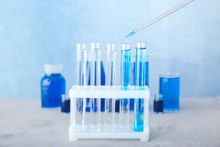 Dripping of color sample into test tube in laboratoryの写真素材