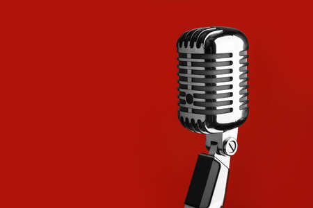 Retro microphone on color backgroundの写真素材