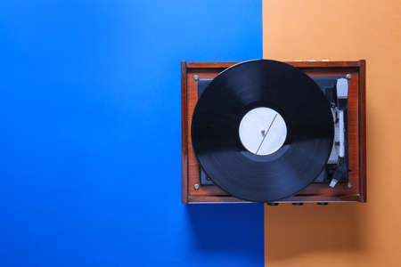 Record player with vinyl disc on color backgroundの写真素材