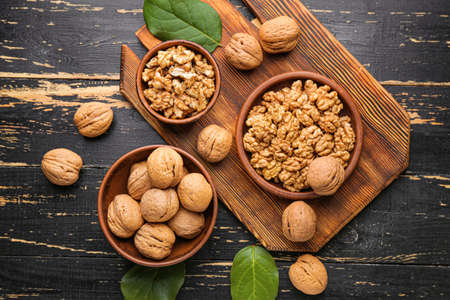 Tasty walnuts on dark background