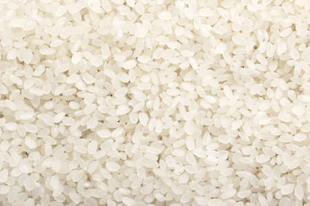 Heap of raw rice as backgroundの写真素材
