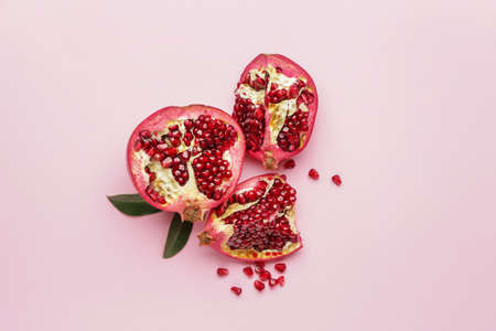 Ripe juicy pomegranates on color backgroundの写真素材