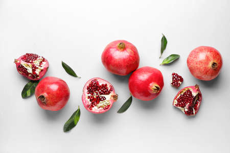 Ripe juicy pomegranates on white backgroundの写真素材