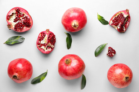 Ripe juicy pomegranates on white backgroundの写真素材