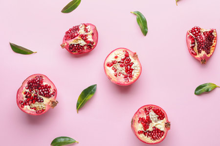 Ripe juicy pomegranates on color backgroundの写真素材