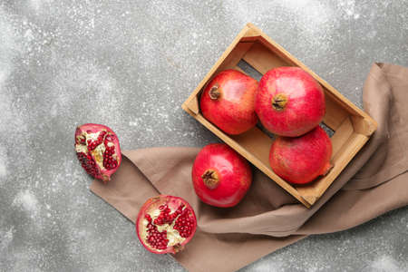 Ripe juicy pomegranates on gray backgroundの写真素材