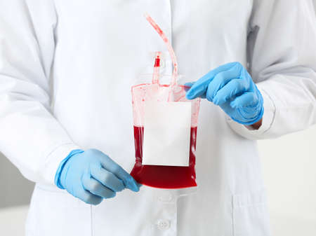 Female doctor with blood pack in hospitalの写真素材