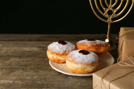 Tasty donuts for Hanukkah on tableの写真素材