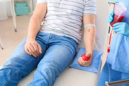 Man donating blood in hospitalの写真素材