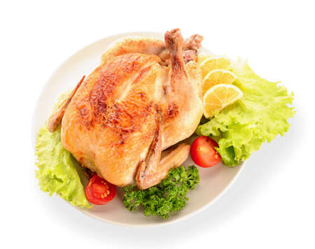 Plate with baked chicken on white backgroundの写真素材