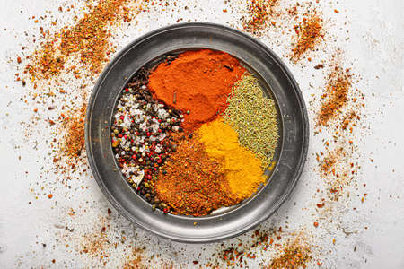 Tray with different spices on white tableの写真素材