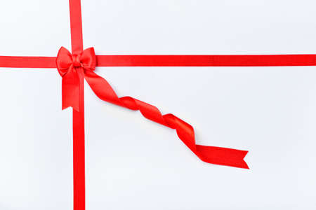 Beautiful red ribbons and bow on white backgroundの写真素材