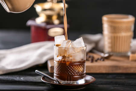 Preparing of cold coffee on dark table