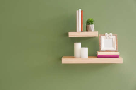 Shelves with decor hanging on color wallの写真素材