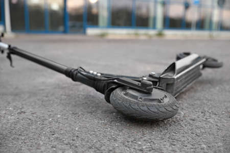 Modern electric kick scooter on asphalt outdoorsの写真素材