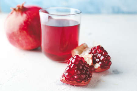 Glass of tasty pomegranate juice on tableの写真素材