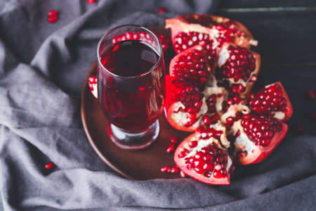 Glass of tasty pomegranate juice on tableの写真素材