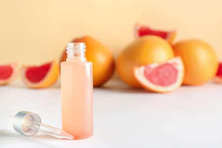 Bottle of grapefruit essential oil on tableの写真素材