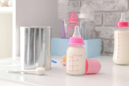 Bottle of baby milk formula on table indoorsの写真素材