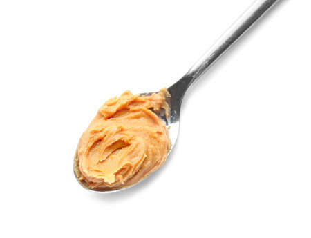 Spoon with tasty peanut butter on white backgroundの写真素材