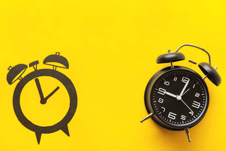 Alarm clock and its drawing on color background