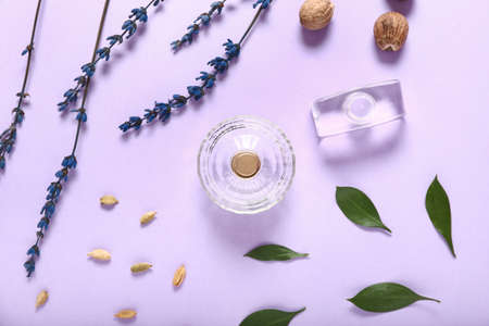 Composition with bottles of perfumes on color background