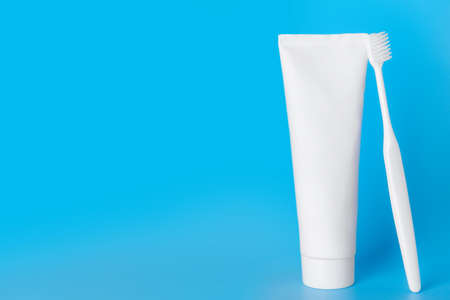 Tooth brush and paste on color background