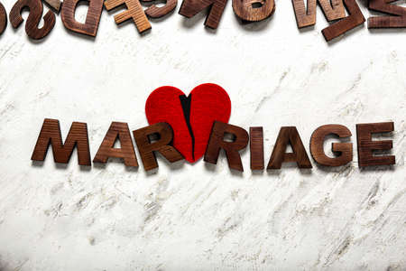 Word MARRIAGE and broken heart on light background. Concept of divorceの写真素材