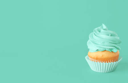 Tasty cupcake on color backgroundの写真素材
