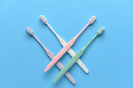 Tooth brushes on color background