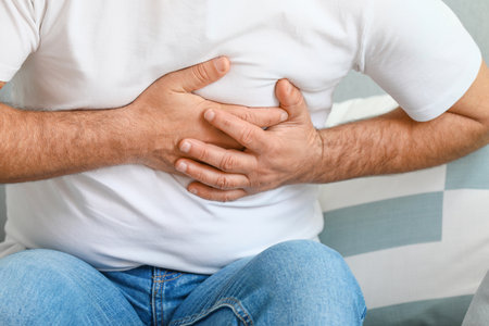 Mature man suffering from heart attack at home, closeupの写真素材