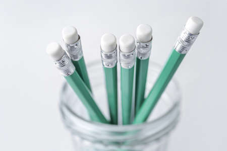 Holder with turquoise pencils on light backgroundの写真素材